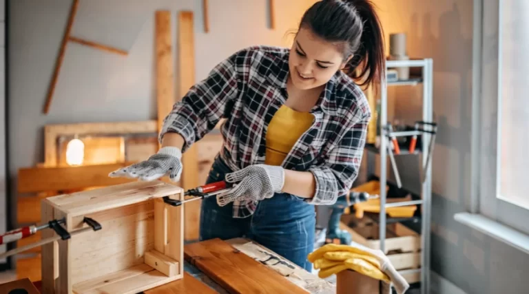 girl holding a wood saw doing DIY carpentry